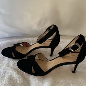 Black suede heeled sandal with ankle strap.